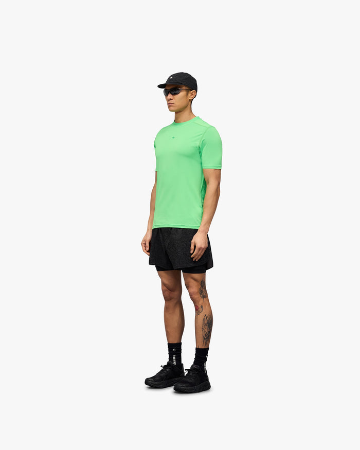 Man wearing a green technical t-shirt on a plain white background | 247 Contour Run T-Shirt in Speed Green | Breathable sweat-wicking running t-shirt with contour print | 247 T-Shirts | Represent Clo
