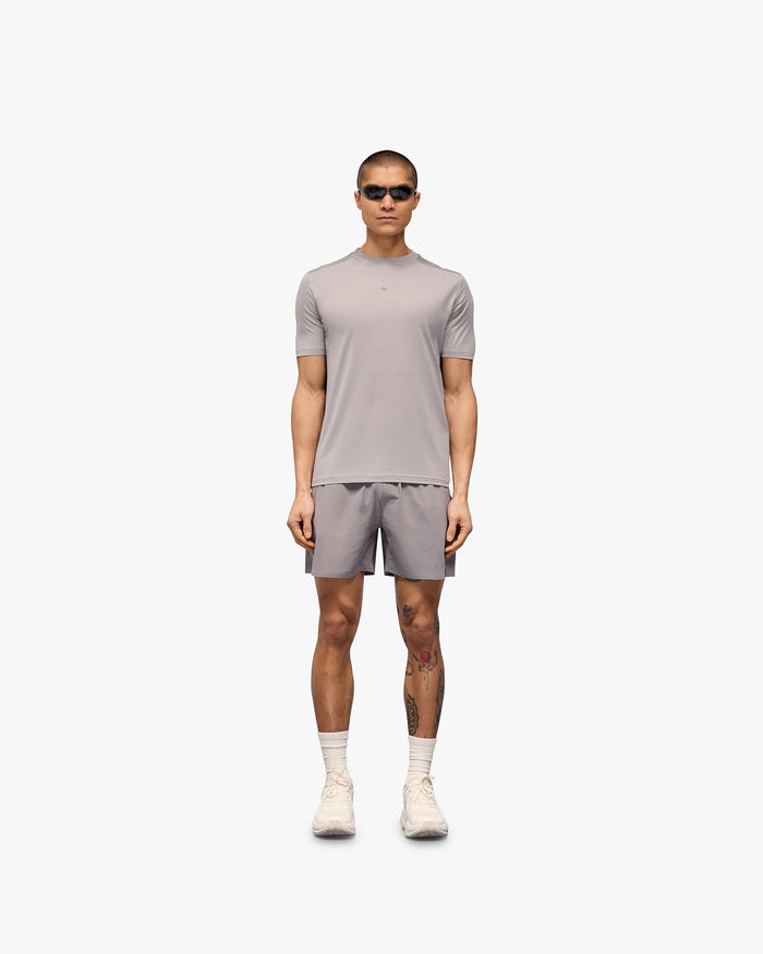 Man wearing a grey t-shirt on a plain white background | 247 Contour Run T-Shirt in Titanium | Breathable mesh running t-shirt with contour print | 247 T-Shirts | Represent Clo