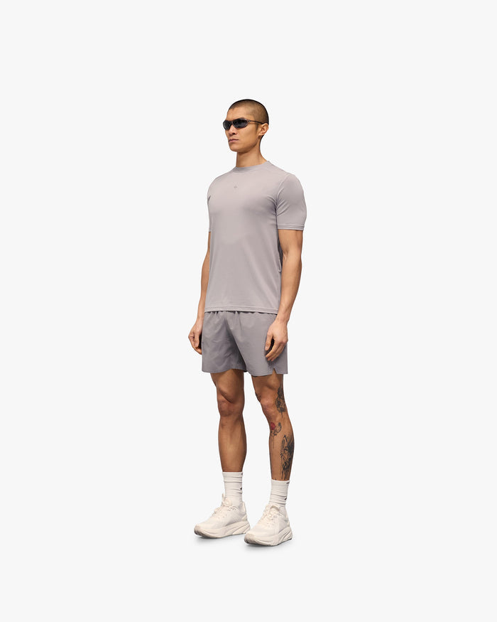 Man wearing a grey t-shirt on a plain white background | 247 Contour Run T-Shirt in Titanium | Running t-shirt with contour print | 247 T-Shirts | Represent Clo
