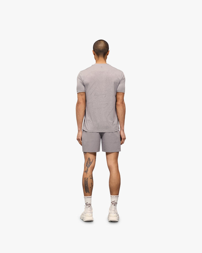 Man wearing a grey running t-shirt on a plain white background | 247 Contour Run T-Shirt in Titanium | Breathable sweat-wicking running t-shirt | 247 T-Shirts | Represent Clo