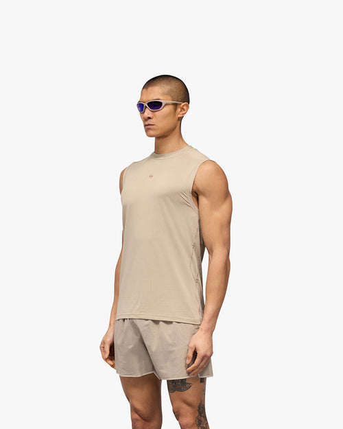 Man wearing a grey running tank on a plain white background | 247 Contour Run Tank in Pebble | Breathable mesh running tank with contour print | 247 T-Shirts | Represent Clo