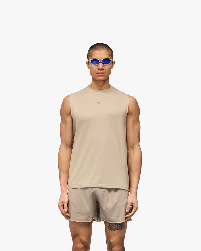 Man wearing a grey running tank on a plain white background | 247 Contour Run Tank in Pebble | Breathable sweat-wicking technical tank | 247 T-Shirts | Represent Clo