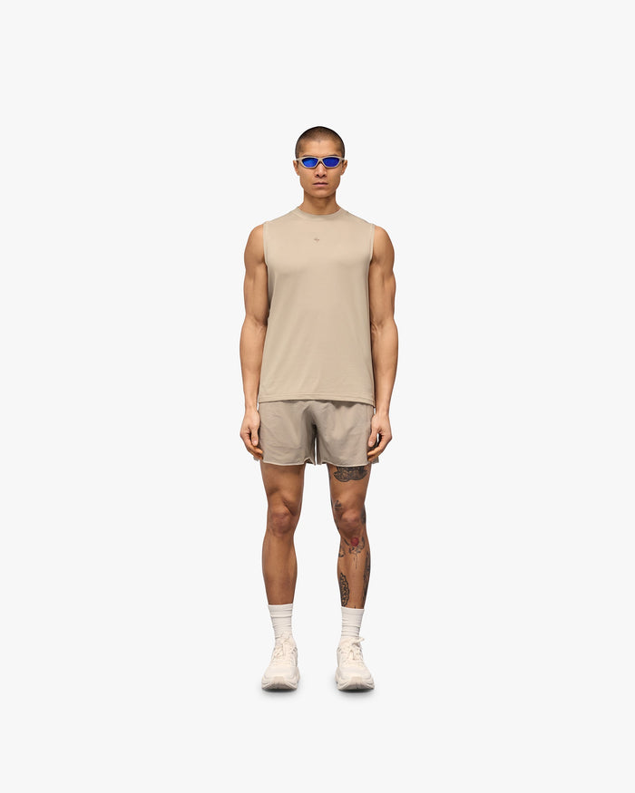 Man wearing a grey running tank on a plain white background | 247 Contour Run Tank in Pebble | Breathable mesh running tank with contour print | 247 T-Shirts | Represent Clo