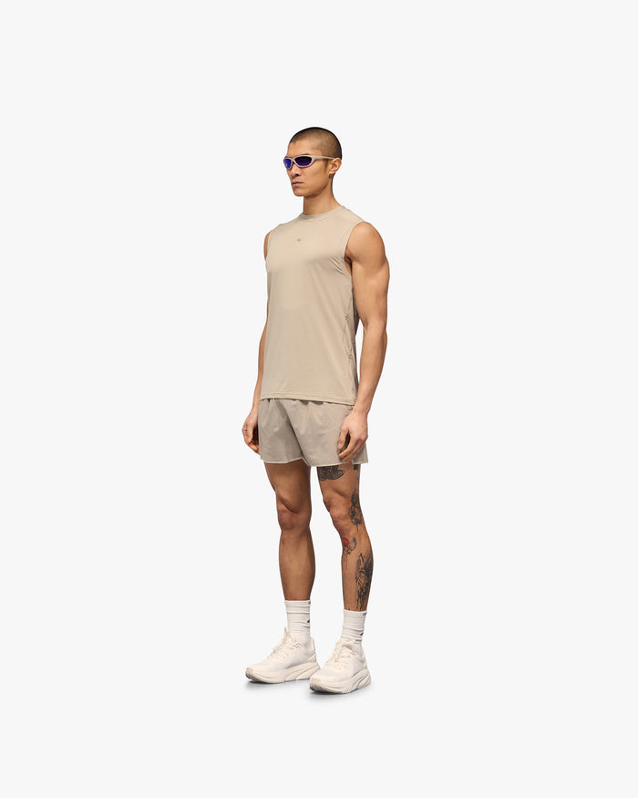 Man wearing a grey running tank on a plain white background | 247 Contour Run Tank in Pebble | Breathable mesh running tank with contour print | 247 T-Shirts | Represent Clo