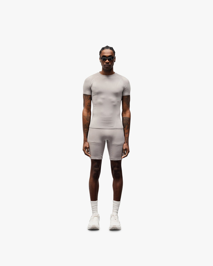 Man wearing grey seamless shorts on a plain white background | 247 DNA Seamless Shorts in Titanium | Seamless shorts with knit structured panels and compression support | 247 Shorts | Represent Clo