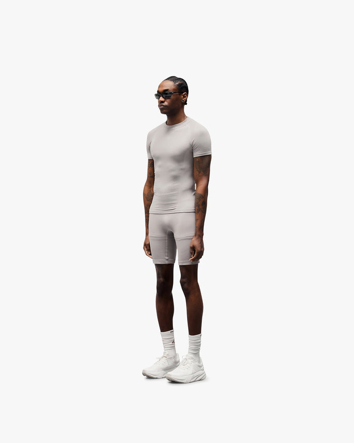 Man wearing seamless grey shorts on a plain white background | 247 DNA Seamless Shorts in Titanium | Seamless shorts with compression support | 247 Shorts | Represent Clo