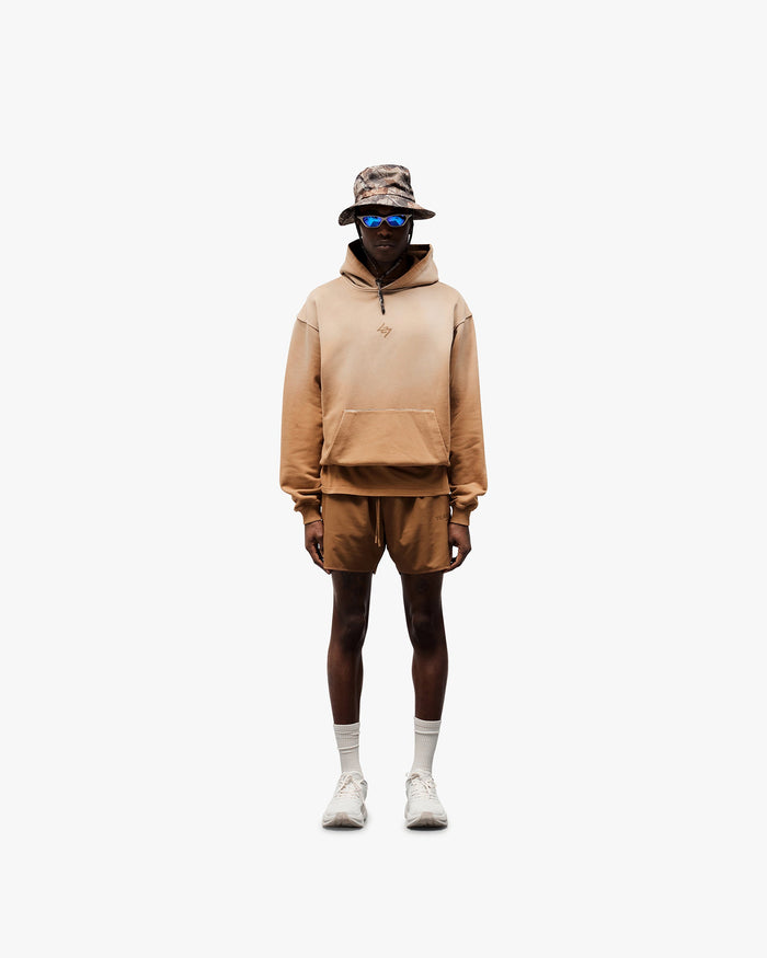 Man wearing an oversized rust hoodie on a plain white background | 247 Motion Oversized Hoodie in Rust | Oversized hoodie with ribbed hem and cuffs | 247 Hoodies | Represent Clo