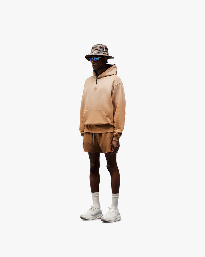 Man wearing an oversized rust hoodie on a plain white background | 247 Motion Oversized Hoodie in Rust | Hoodie with ribbed hem and cuffs | 247 Hoodies | Represent Clo