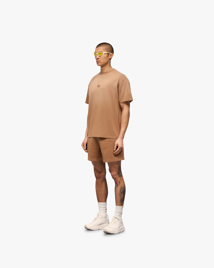 Man wearing an oversized rust t-shirt on a plain white background | 247 Motion Oversized T-Shirt in Rust | Oversized t-shirt with 2 way stretch and graphic print | 247 T-Shirts | Represent Clo