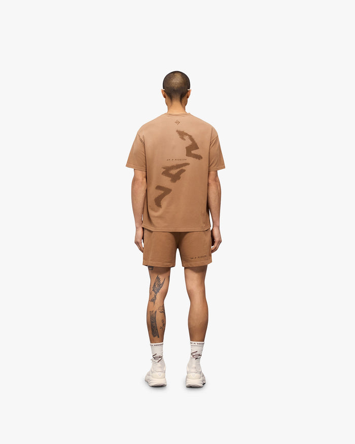 Man wearing an oversized rust t-shirt on a plain white background | 247 Motion Oversized T-Shirt in Rust | T-shirt with 2 way stretch and antibacterial properties | 247 T-Shirts | Represent Clo