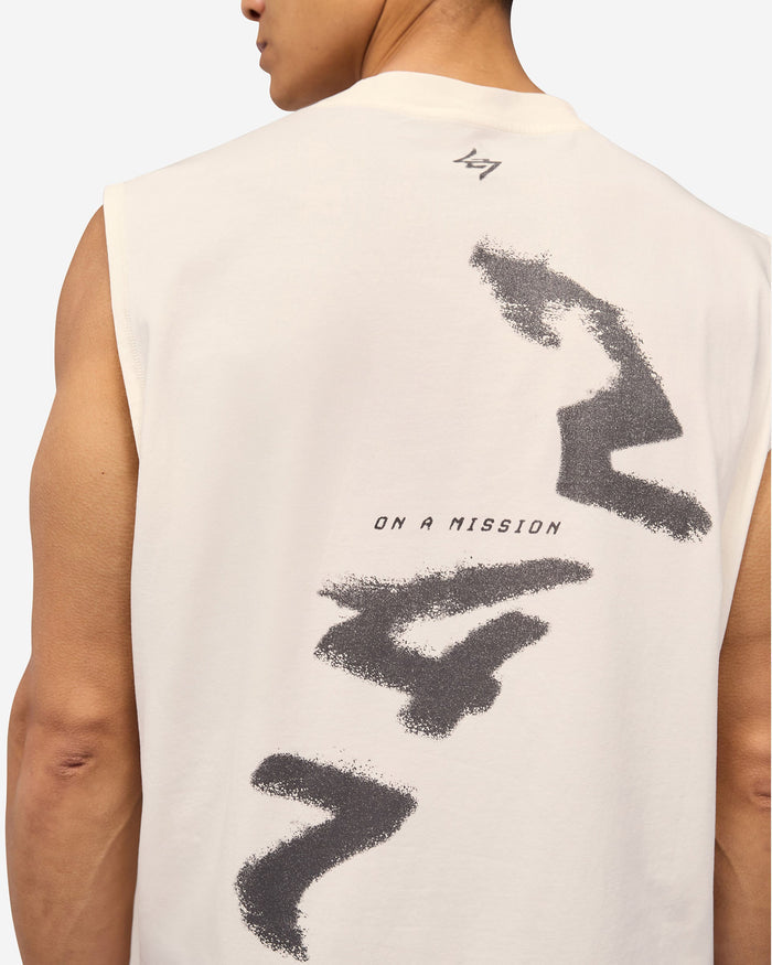 Man wearing an oversized white tank on a plain white background | 247 Motion Oversized Tank in Flat White | Oversized tank with water based graphic print | 247 T-Shirts | Represent Clo