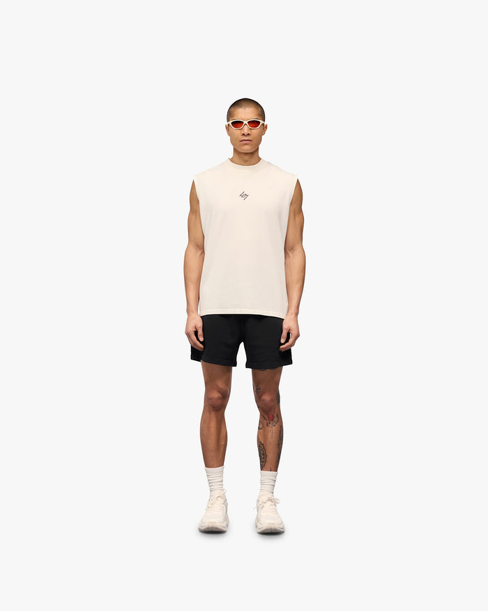 Man wearing a white oversized tank top on a plain white background | 247 Motion Oversized Tank in Flat White | Breathable tank top with 2-way stretch | 247 T-Shirts | Represent Clo