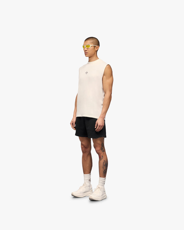 Man wearing an oversized white tank top on a plain white background | 247 Motion Oversized Tank in Flat White | Tank top with water based graphic print | 247 T-Shirts | Represent Clo