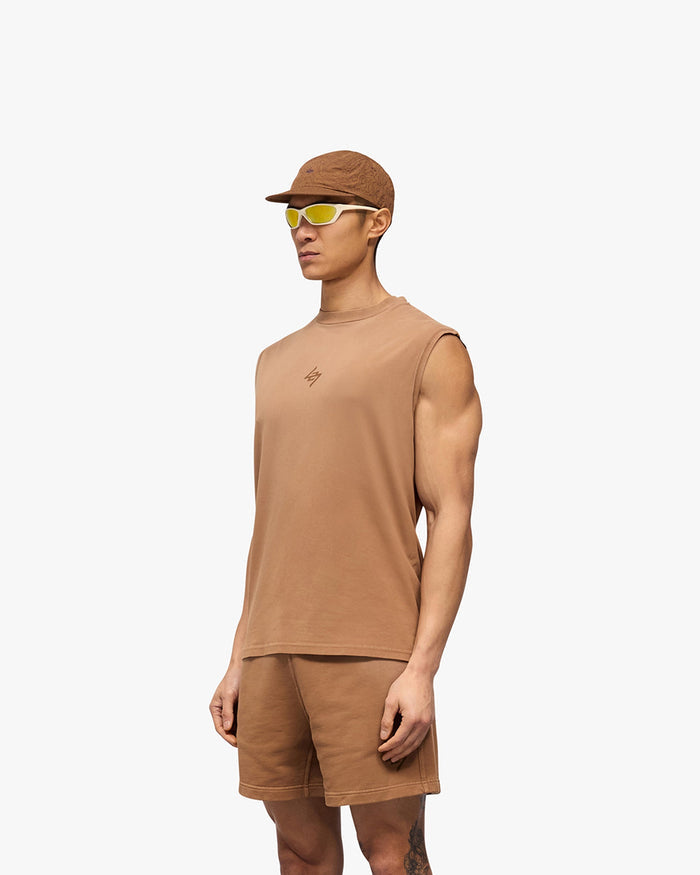 Man wearing an oversized rust tank top on a plain white background | 247 Motion Oversized Tank in Rust | Oversized tank with 2 way stretch and graphic print | 247 T-Shirts | Represent Clo