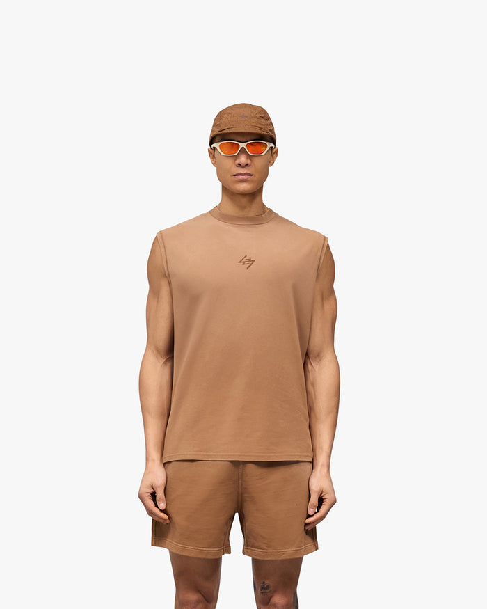 Man wearing an oversized rust tank top on a plain white background | 247 Motion Oversized Tank in Rust | Oversized tank with 2 way stretch and sweat wicking | 247 T-Shirts | Represent Clo