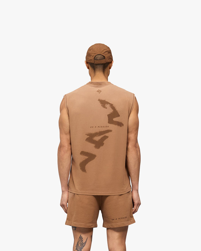 Man wearing a rust tank on a plain white background | 247 Motion Oversized Tank in Rust | Oversized tank with graphic print and stretch | 247 T-Shirts | Represent Clo