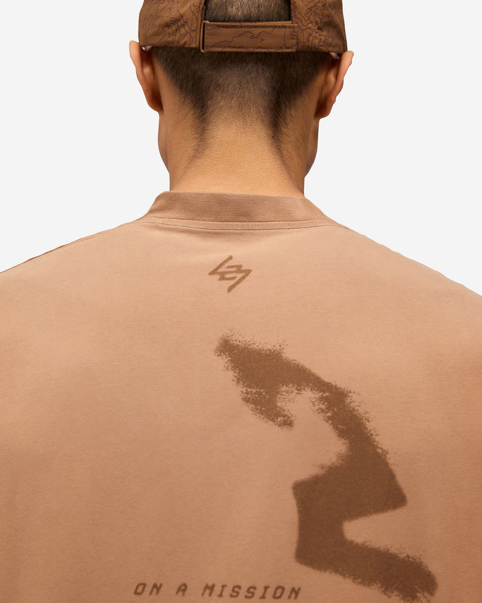 Man wearing an oversized rust tank on a plain white background | 247 Motion Oversized Tank in Rust | Oversized tank with water based graphic print | 247 T-Shirts | Represent Clo