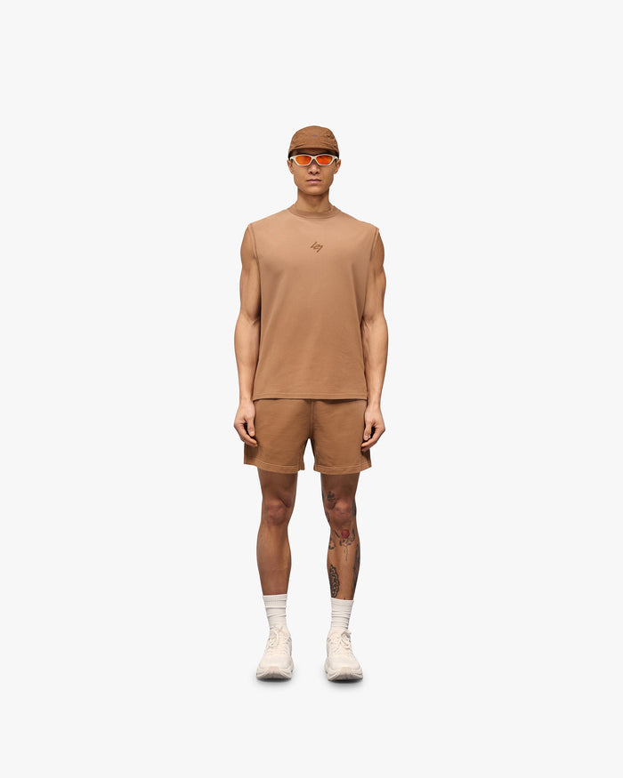 Man wearing a rust sleeveless tank on a plain white background | 247 Motion Oversized Tank in Rust | Oversized tank with 2 way stretch and vintage aesthetic | 247 T-Shirts | Represent Clo