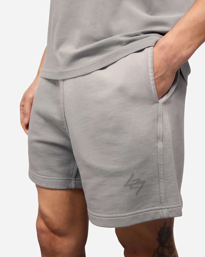 Man wearing grey jersey shorts on a plain white background | 247 Motion Shorts in Titanium | Shorts with elasticated waistband and internal drawcord | 247 Shorts | Represent Clo