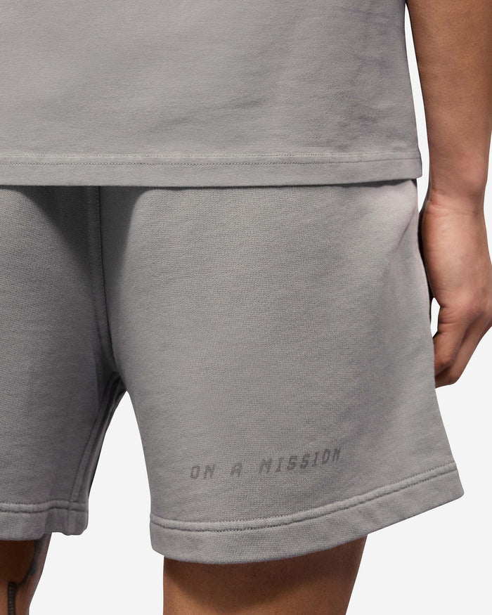 Man wearing grey shorts on a plain white background | 247 Motion Shorts in Titanium | Cotton shorts with elasticated waistband and graphic print | 247 Shorts | Represent Clo