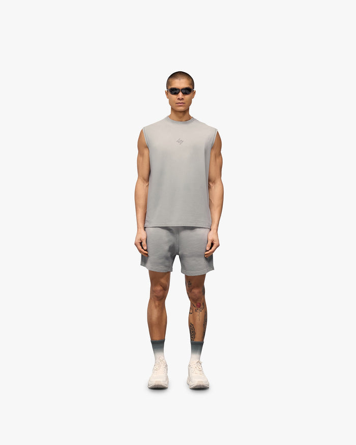 Man wearing grey jersey shorts on a plain white background | 247 Motion Shorts in Titanium | Shorts with elasticated waistband and water based graphic print | 247 Shorts | Represent Clo