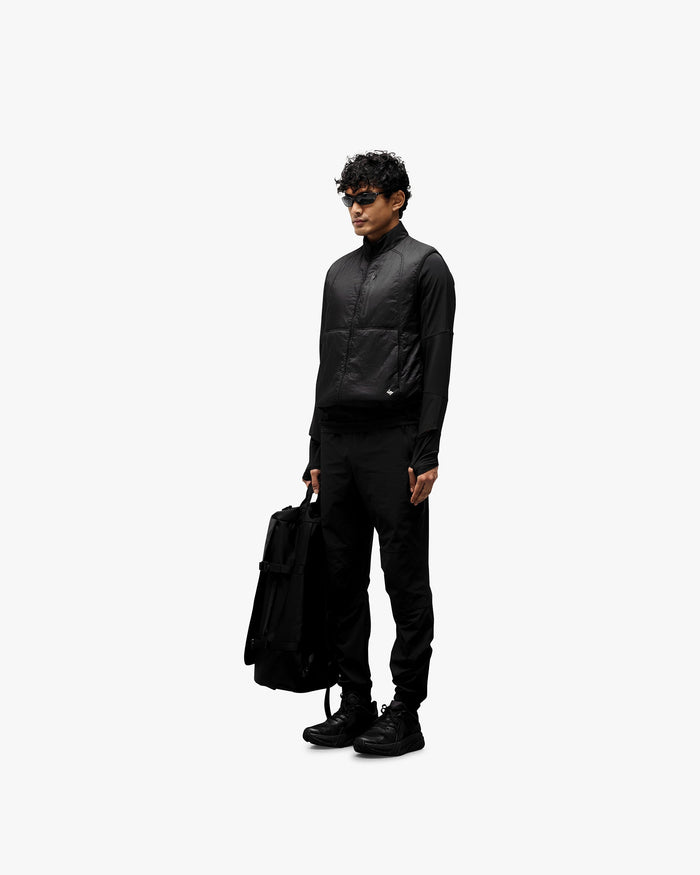 Man wearing a black running gilet on a plain white background | 247 Run Gilet in Black | Performance running gilet with windproof insulation | 247 Outerwear | Represent Clo