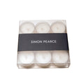 Nine white tealights in clear plastic cups arranged in a clear box with black Simon Pearce band.