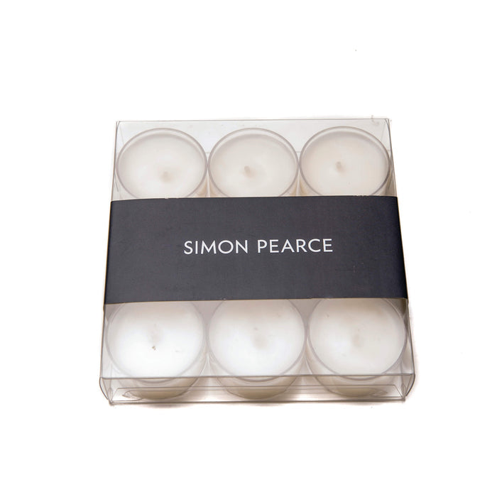 Nine white tealights in clear plastic cups arranged in a clear box with black Simon Pearce band.