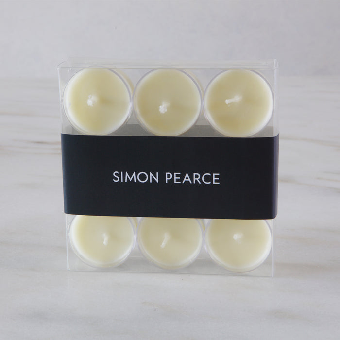 Nine cream-colored tealights in clear plastic cases with black Simon Pearce branded band.