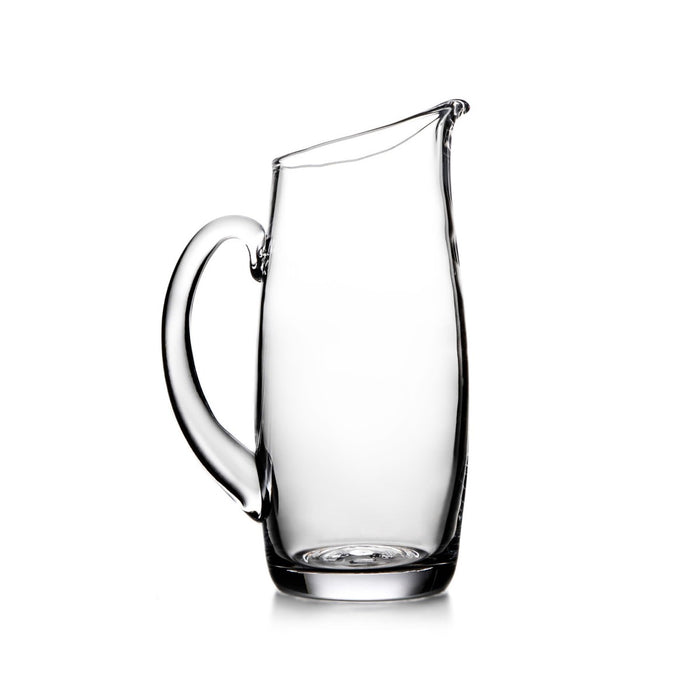 Clear glass pitcher with curved handle and wide spout opening.
