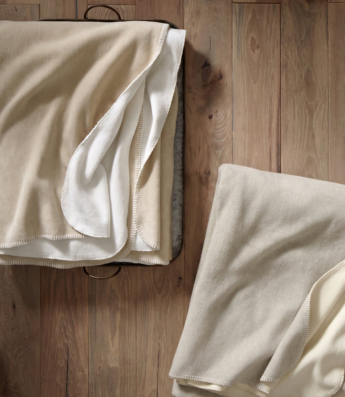 Folded Alta Reversible Cotton Blanket On Table White Pearl Colors