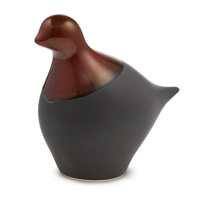 Brown and charcoal sculptural dove figurine with curved body and textured surface finish.