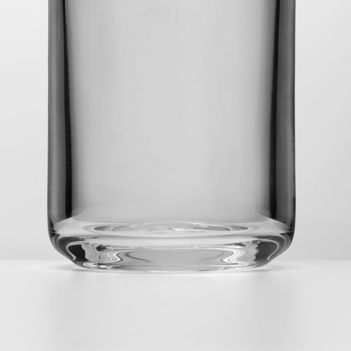 Clear glass pitcher with tall cylindrical body and thick rounded base, shown from front view.