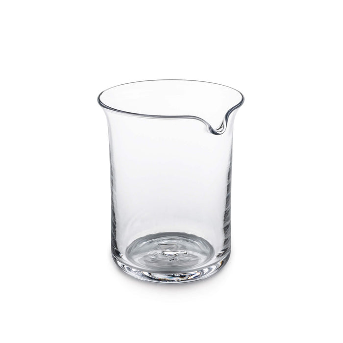 Clear glass pitcher with curved pouring spout and thin rim against white background.