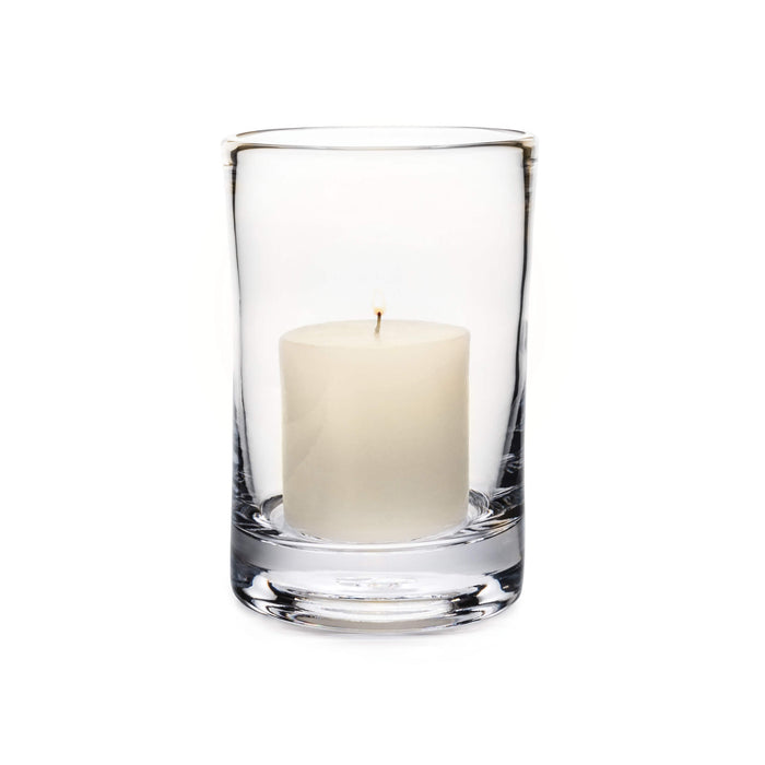 Clear glass hurricane vase with cream-colored pillar candle inside.