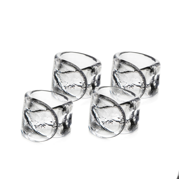 Four clear glass napkin rings with leaf-etched design arranged in two rows.