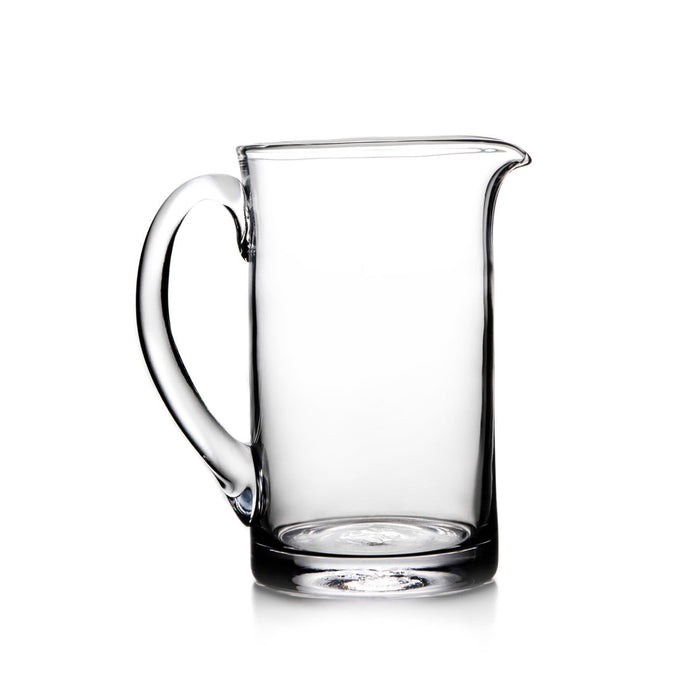 Clear glass pitcher with curved handle and pouring spout.