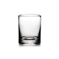 Empty clear glass whiskey tumbler with thick base and weighted bottom on white background.