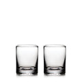 Two clear glass whiskey glasses with thick bases, empty and positioned side by side.