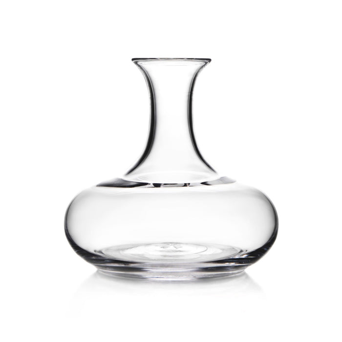 Clear glass wine decanter with wide rounded base and tapered neck on white background.