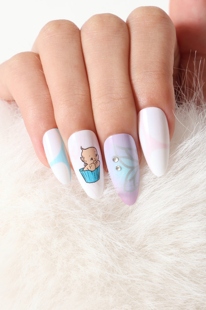 Aura Kewpie press-on nails: baby in blue cup, pastel abstract, rhinestones.