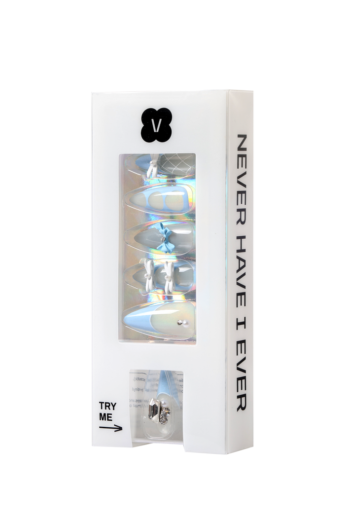 Baby blue press-on nails with delicate bow and pearl accents in packaging.