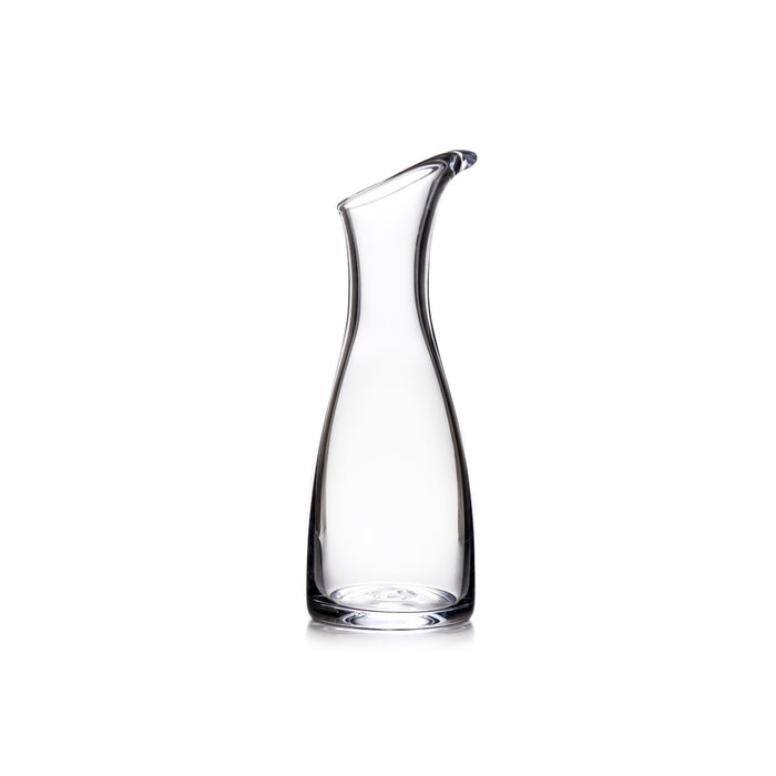 Clear glass carafe with curved sides and a pouring spout at the top.