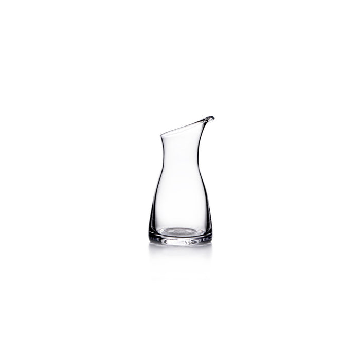 Clear glass carafe with curved sides and a spout at the top.