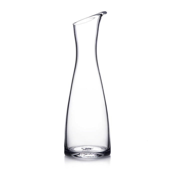 Clear glass carafe with curved sides and a pouring spout at the top.