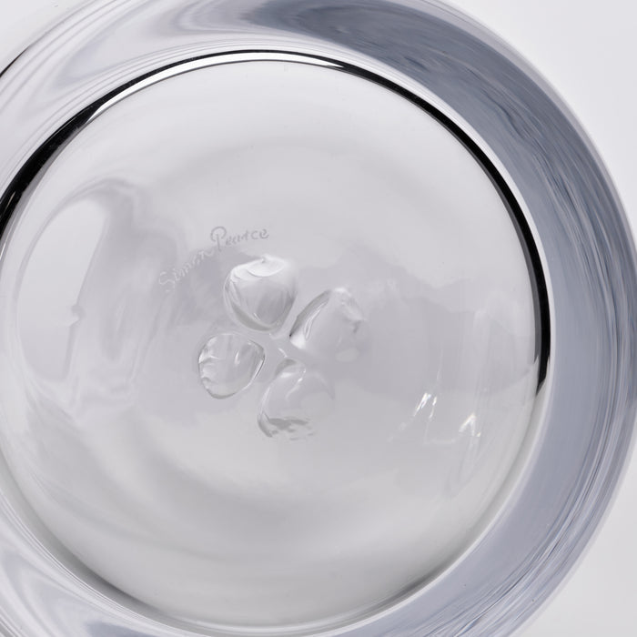 Clear glass carafe with ice cubes inside, viewed from above showing the circular opening and gray-tinted rim.
