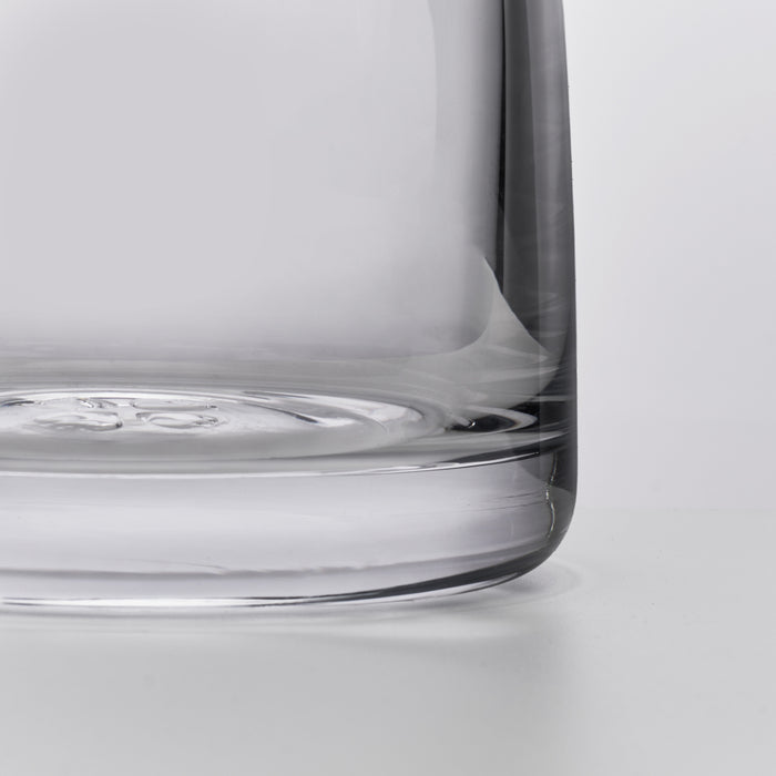 Clear glass carafe with rounded cylindrical body and wide base, shown in profile view.