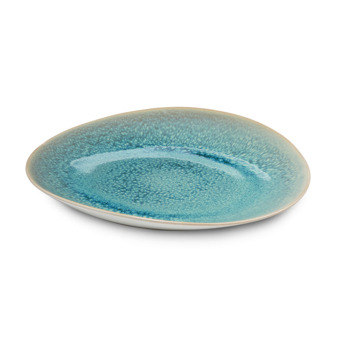 Lagoon blue ceramic plate with textured glaze and white rim, shown from angled view.