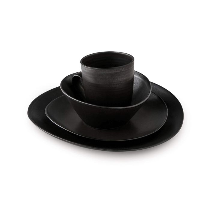 Slate-colored dinnerware set with stacked plate, bowl, and cup showing textured finish.