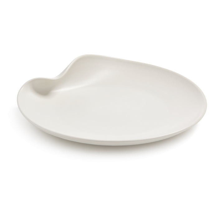 White ceramic platter with organic curved shape and small handle indent on one side.